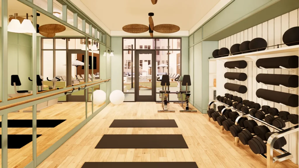 Fitness room with mirrors barre yoga mats and dumbells
