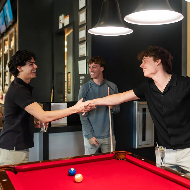 Guys playing billards at local bar
