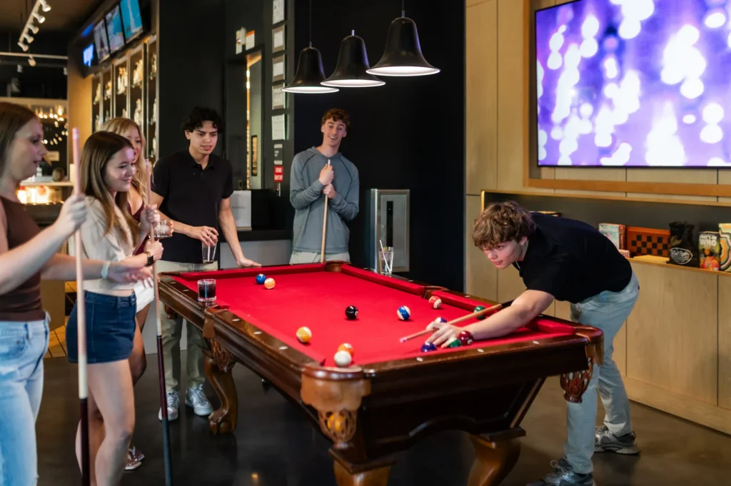 Friends playing billiards at local bar