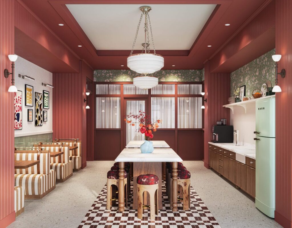 Community kitchen with booth seating and Smeg refrigerator at Heyday Raleigh