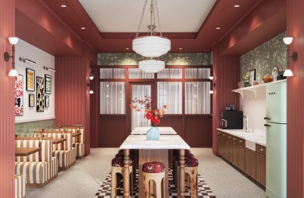 Community kitchen with booth seating and Smeg refrigerator at Heyday Raleigh