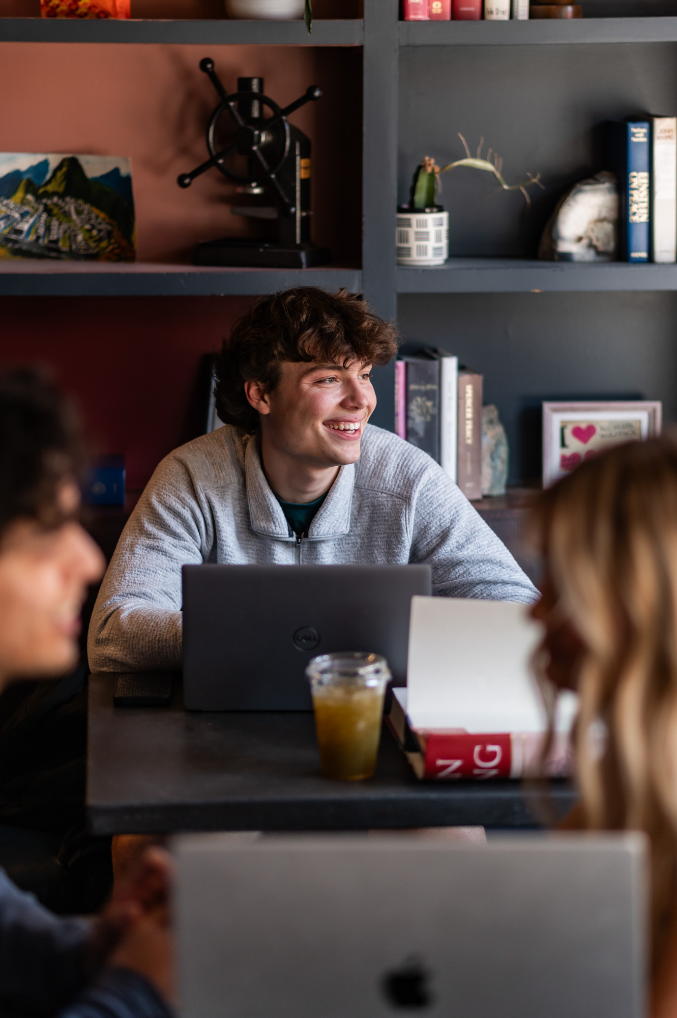 Student working on laptop in local coffee shop