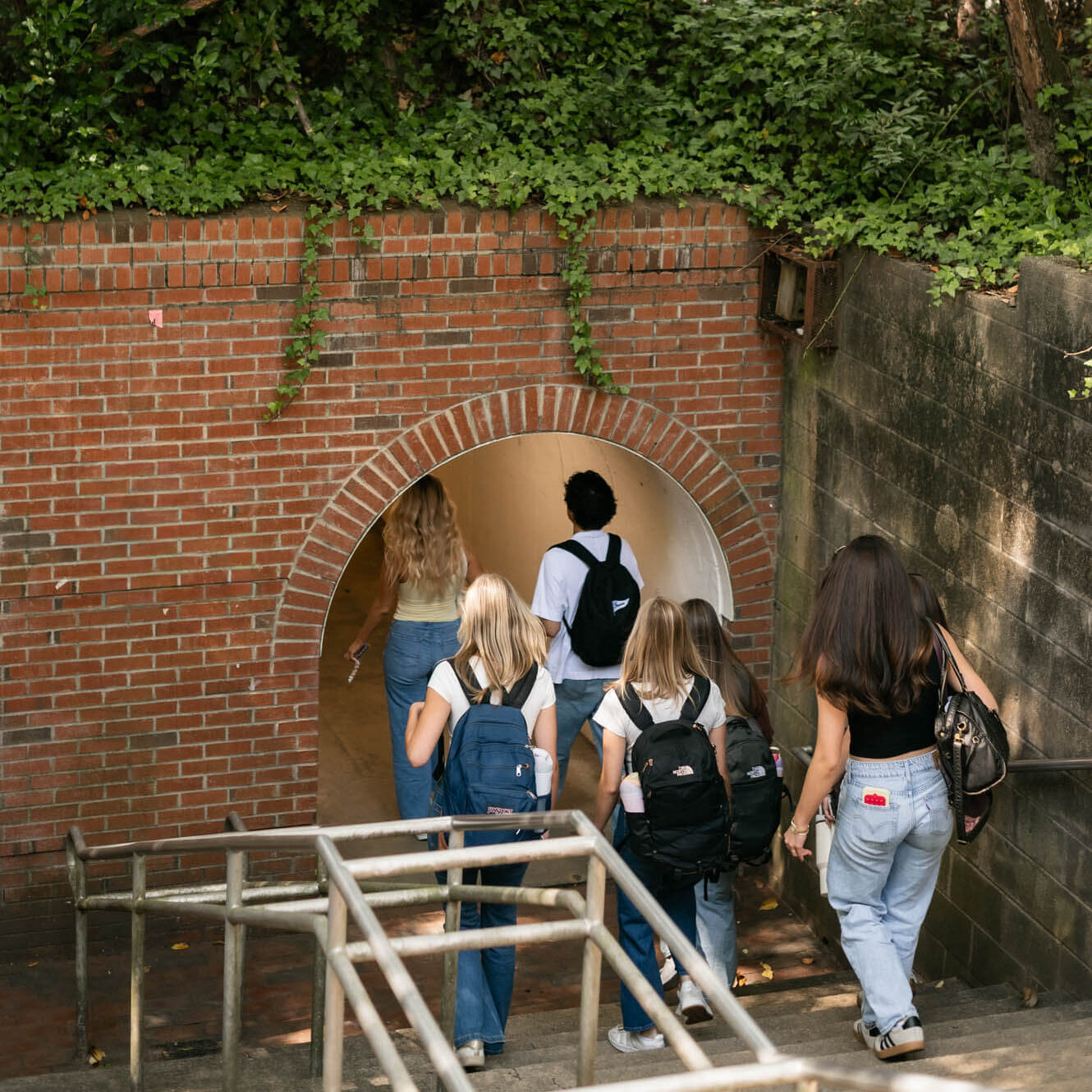 Students walking through tunnel on the way to class