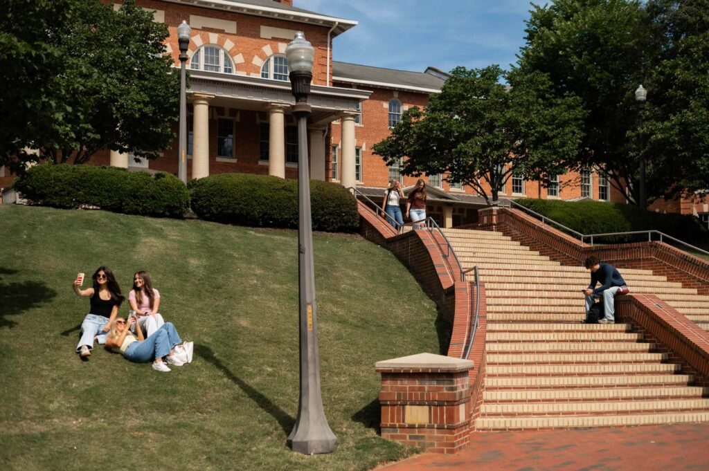 View of students on steps and grass outside the 1911 Building