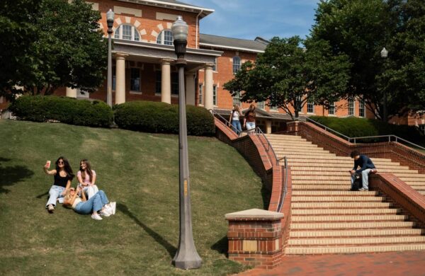 View of students on steps and grass outside the 1911 Building