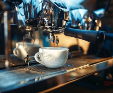 commercial espresso machine extracting coffee